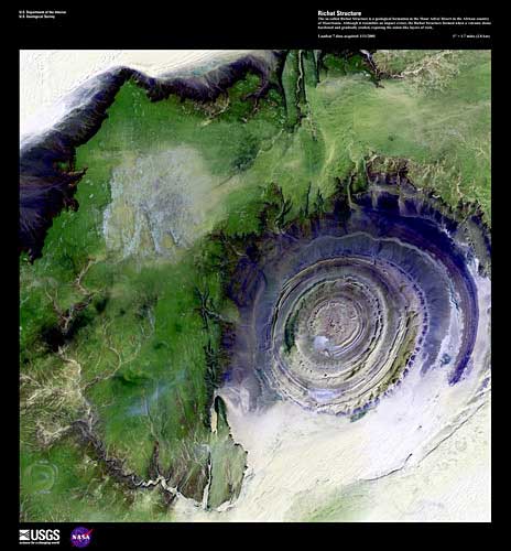 Richat Structure, imaged on January 1, 2001 by Landsat 7. The so-called Richat Structure is a geological formation in the Maur Adrar Desert in the African country of Mauritania. Although it resembles an impact crater, the Richat Structure formed when a volcanic dome hardened and gradually eroded, exposing the onion-like layers of rock. Credit: USGS/EROS.