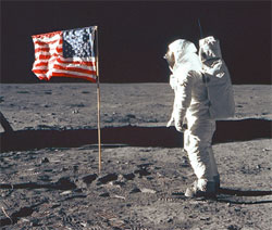 Astronaut Edwin E. Aldrin Jr., lunar module pilot of the first lunar landing mission, poses for a photograph beside the deployed United States flag during an Apollo 11 extravehicular activity (EVA) on the lunar surface on July 20, 1969.