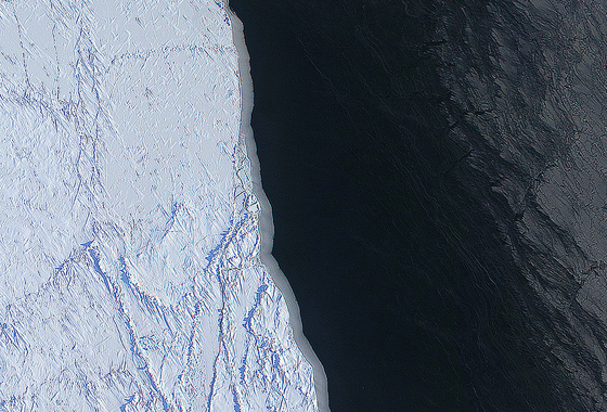 The margin of a large lead of open water (dark) and thin grease ice (gray, right) in the Chukchi Sea between Alaska and Russia. The image was made with several frames from the Digital Mapping System (DMS) onboard the NASA P-3. Credit: NASA/DMS/Eric Fraim