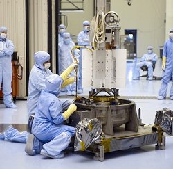 Clean-suited technicians assemble a TE generator for a spacecraft. NASA's expertise in this technology can help cars and trucks to run more efficiently.
