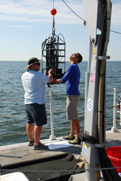Scientists used multiple instruments to measure water quality. Here, members of the team deploy a package of instruments that take measurements of light interacting with particles in the water. Photo courtesy of Maria Tzortziou
