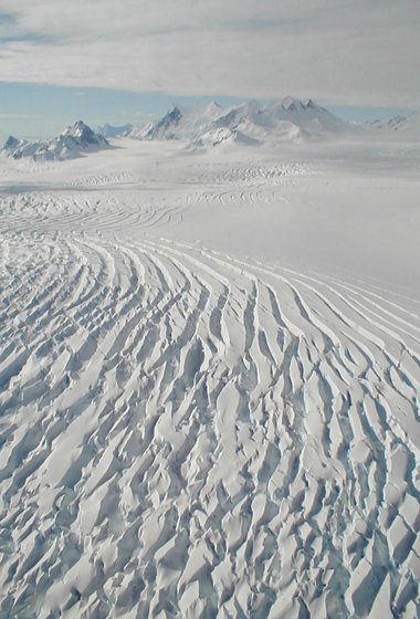 The frozen, inhospitable surface features of Alexander Island in Antarctica were viewed at close range during one of the final low-level flights by NASA's DC-8 flying laboratory during the 2011 Antarctic IceBridge mission. Credit: NASA/Chris Miller