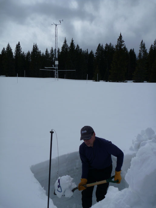 Tom Painter digging out a new snowpit. Samples will be used to measure the melt rates of dirty snow.