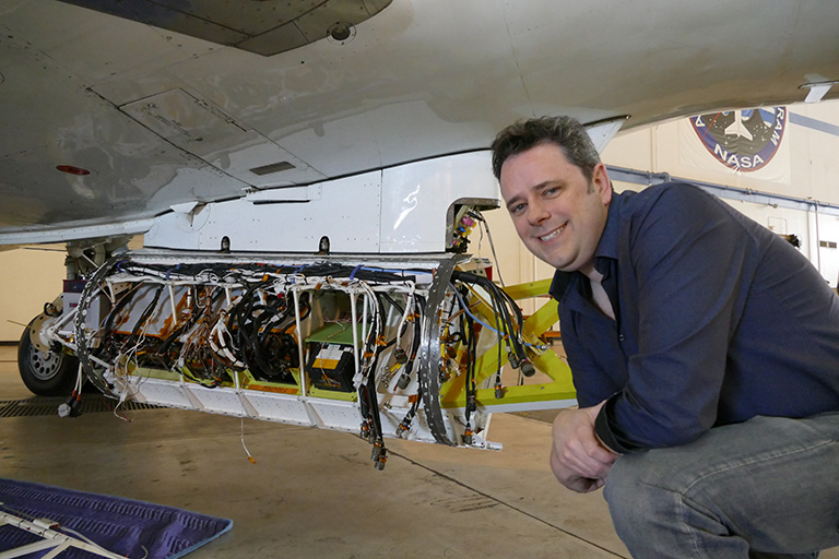 Dr. Josh Willis oversees integration of the GLISTIN-A radar instrument to the belly of the aircraft.