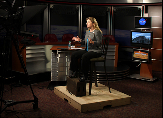  Alone on the set, Michelle Thaller of NASA's Goddard Space Flight Center communicates through the camera lens to a TV station audience she can’t see.