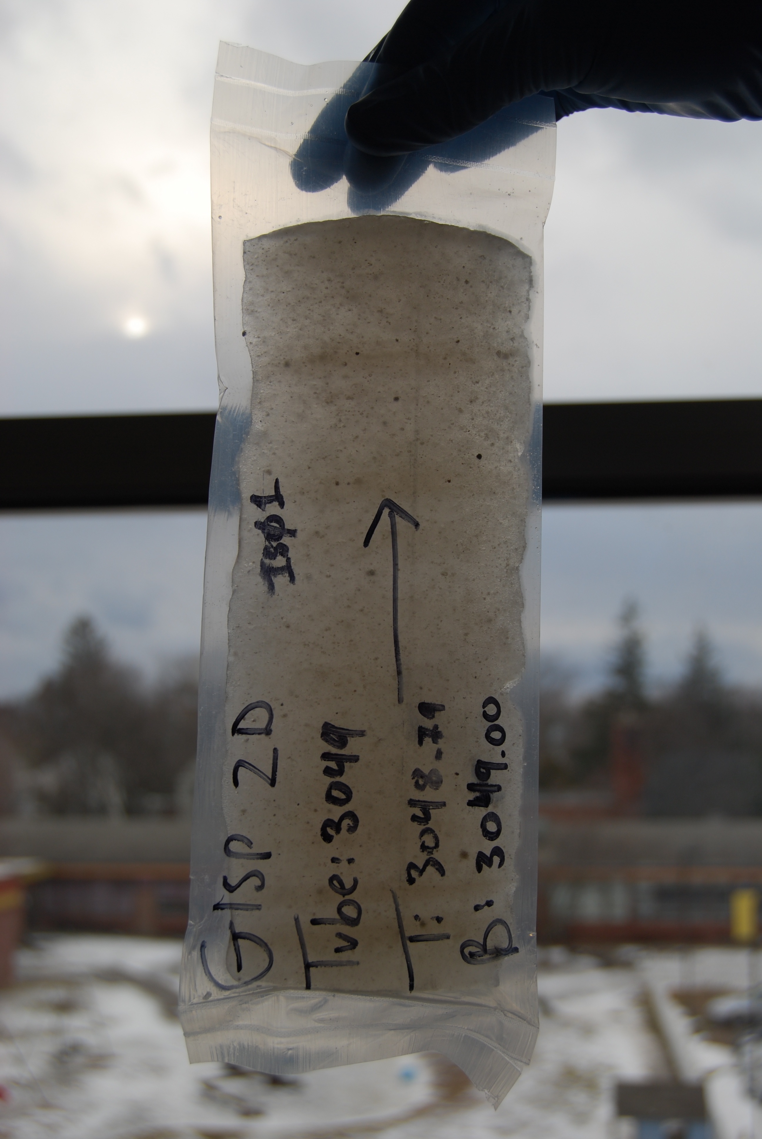 Piece of the GISP2 ice core that the researchers analyzed for the isotope beryllium-10, showing silt and sand embedded in ice. Soon after this picture was taken, the ice was crushed in the University of Vermont clean lab and the sediment was isolated for analysis. Credit: Paul Bierman, University of Vermont