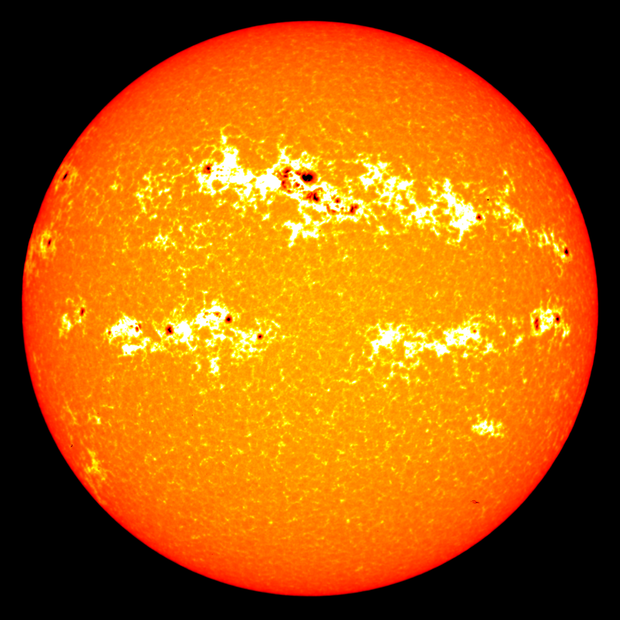 Dark sunspots and bright areas around them called faculae, visible in this 2001 solar image, cause most of the variation in total solar irradiance. Credit: NASA/GSFC/SVS