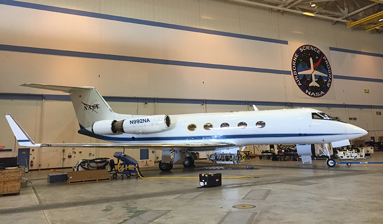One of NASA's modified G-III aircraft in the hangar at Armstrong Flight Research Center being prepped for a mission to study glaciers around Greenland.
