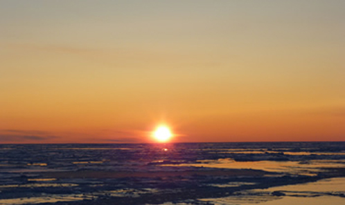 As the sun sets over the Arctic Ocean and the air and water cool, sea ice begins its annual freeze-up. Arctic sea ice appears to have reached its minimum extent for the year--it will now continue to expand until March or April. This photograph was taken over the Arctic Ocean in September, 2008. Credit: Collection of Dr. Pablo Clemente-Colon, Chief Scientist National Ice Center, NOAA
