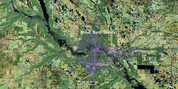 May 16, 2011, before the flooding began. The Souris River flows through the middle of Minot, N.D. and is within its banks in this image, which was taken by Landsat 5. Credit: USGS/NASA.