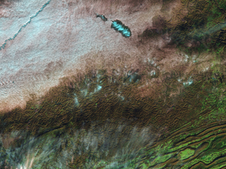 This image, taken by the Landsat-5 satellite on December 11, 2009, shows the unique conditions in which holes in clouds form. Credit: Robert Simmon/NASA Earth Observatory