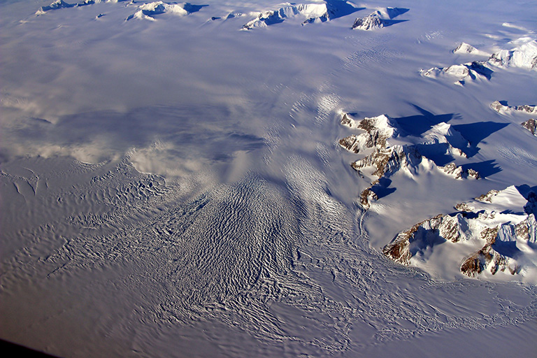 Ice drainage from the western Antarctic Peninsula onto the northern George VI Ice Shelf on Oct. 14, 2016. Credit: NASA/John Sonntag.