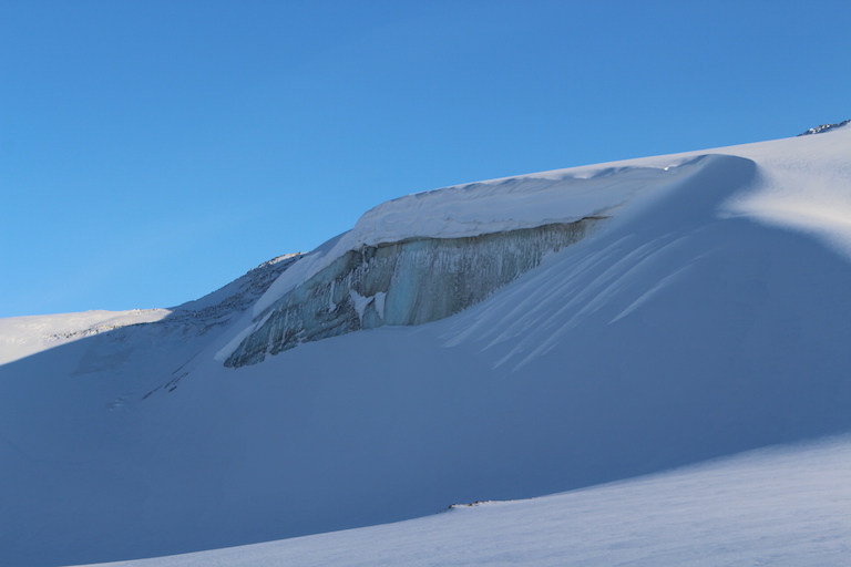 An exposed wall reveals ice that is hundreds of thousands of years old on the edge of the Greenland ice cap. Credit: NASA/JPL.