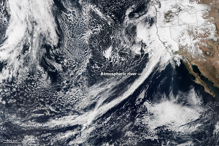 A tight arc of clouds stretching from Hawaii to California