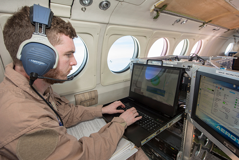 Radar operator monitors incoming wind data during science flight