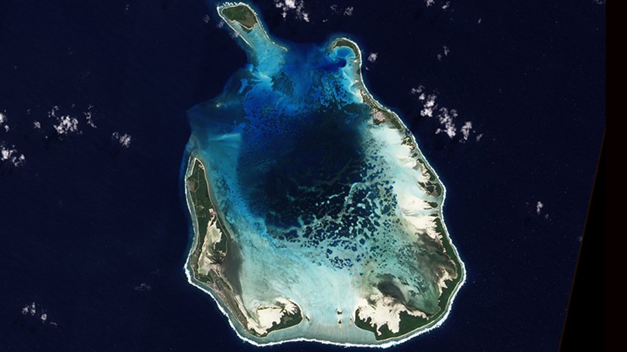 Dark blue seawater surrounds an island.