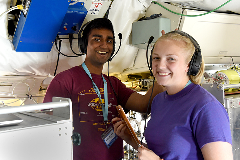 SARP participants Sujay Rajkumar and Kiersten Johnson on board the DC-8 operating Whole Air Sampling instrumentduring a science flight on June 26, 2018. Credit: NASA/Megan Schill