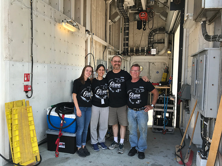 The WHOI EXPORTS team showed off their glow-in-the-dark ocean twilight zone t-shirts prior to departure from Seattle in August.