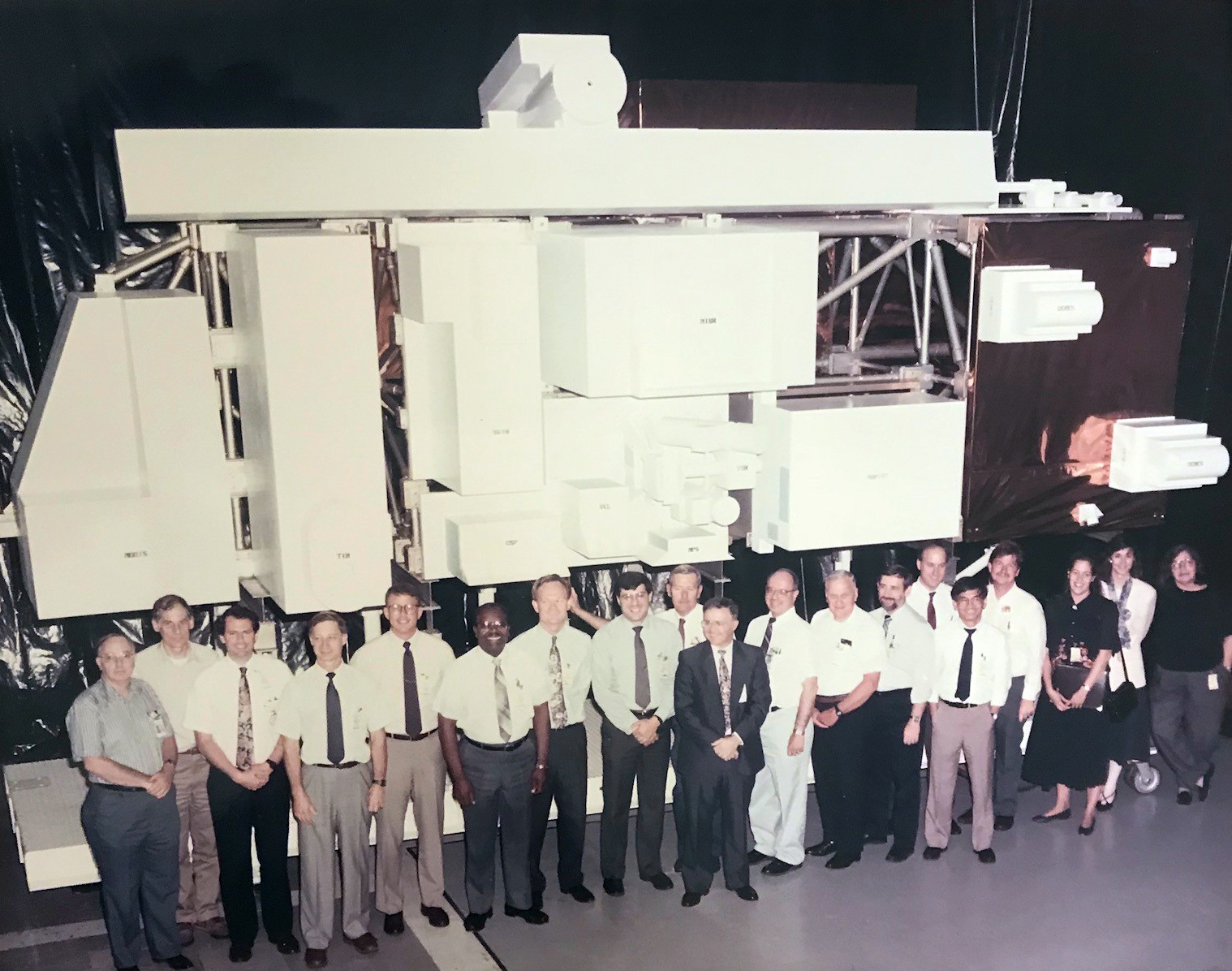 NASA scientists, engineers and designers pose for a group photo in front of the Terra model.