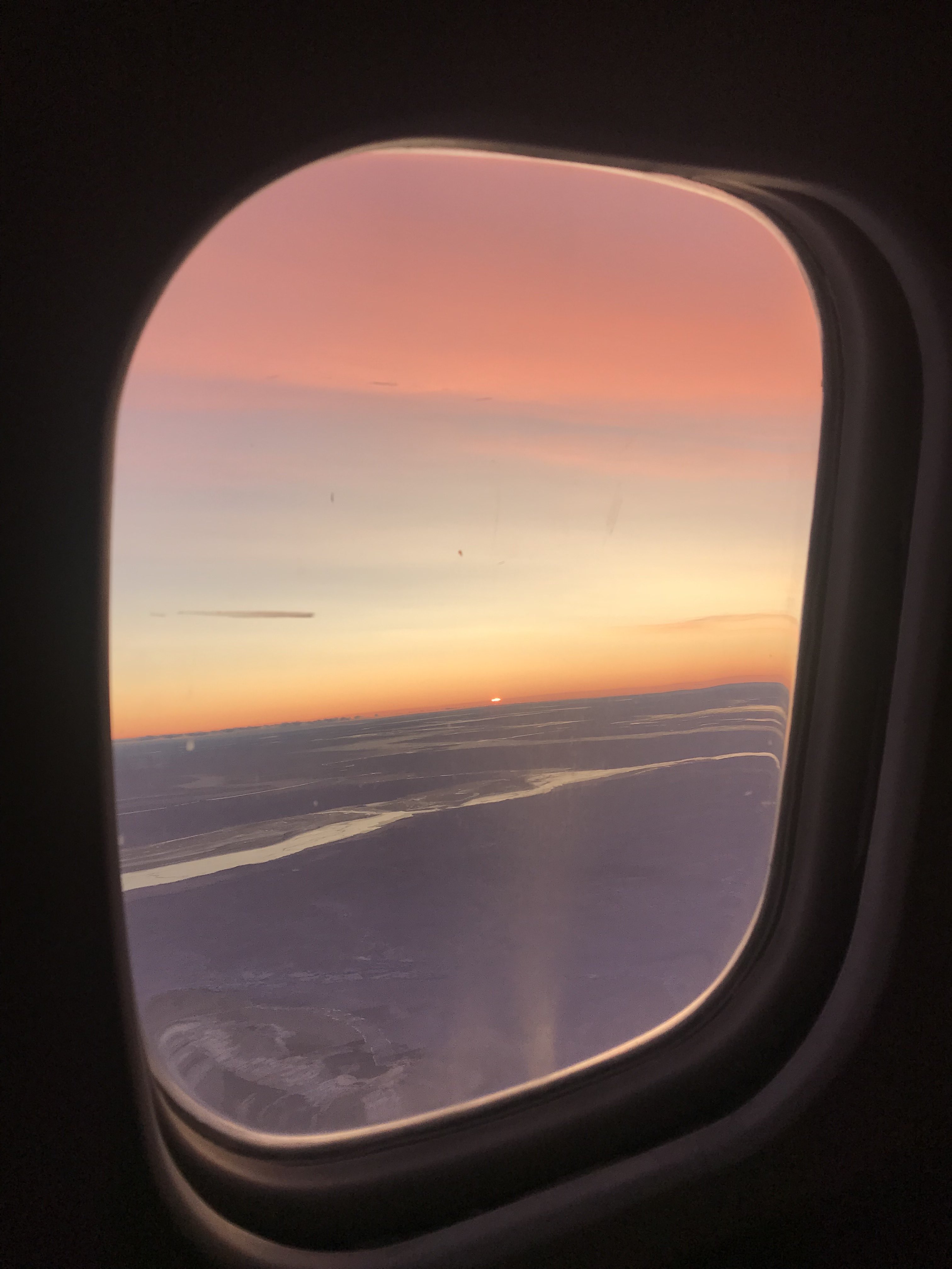 Sunrise over the Weddell Sea and sea ice below from the window of the DC-8