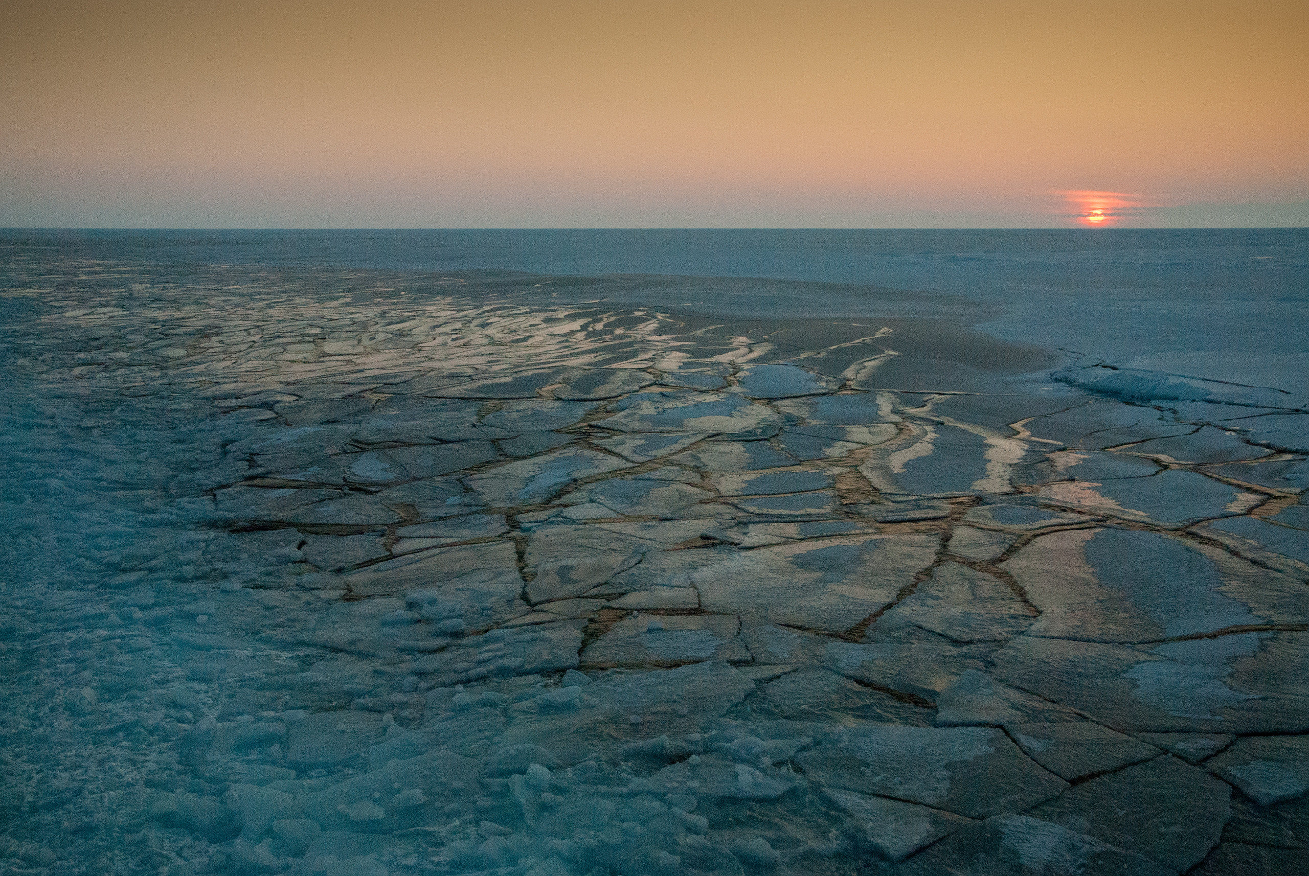 The sun setting over the Arctic sea ice pack, as observed during the Beaufort Gyre Exploration Project in October 2014.