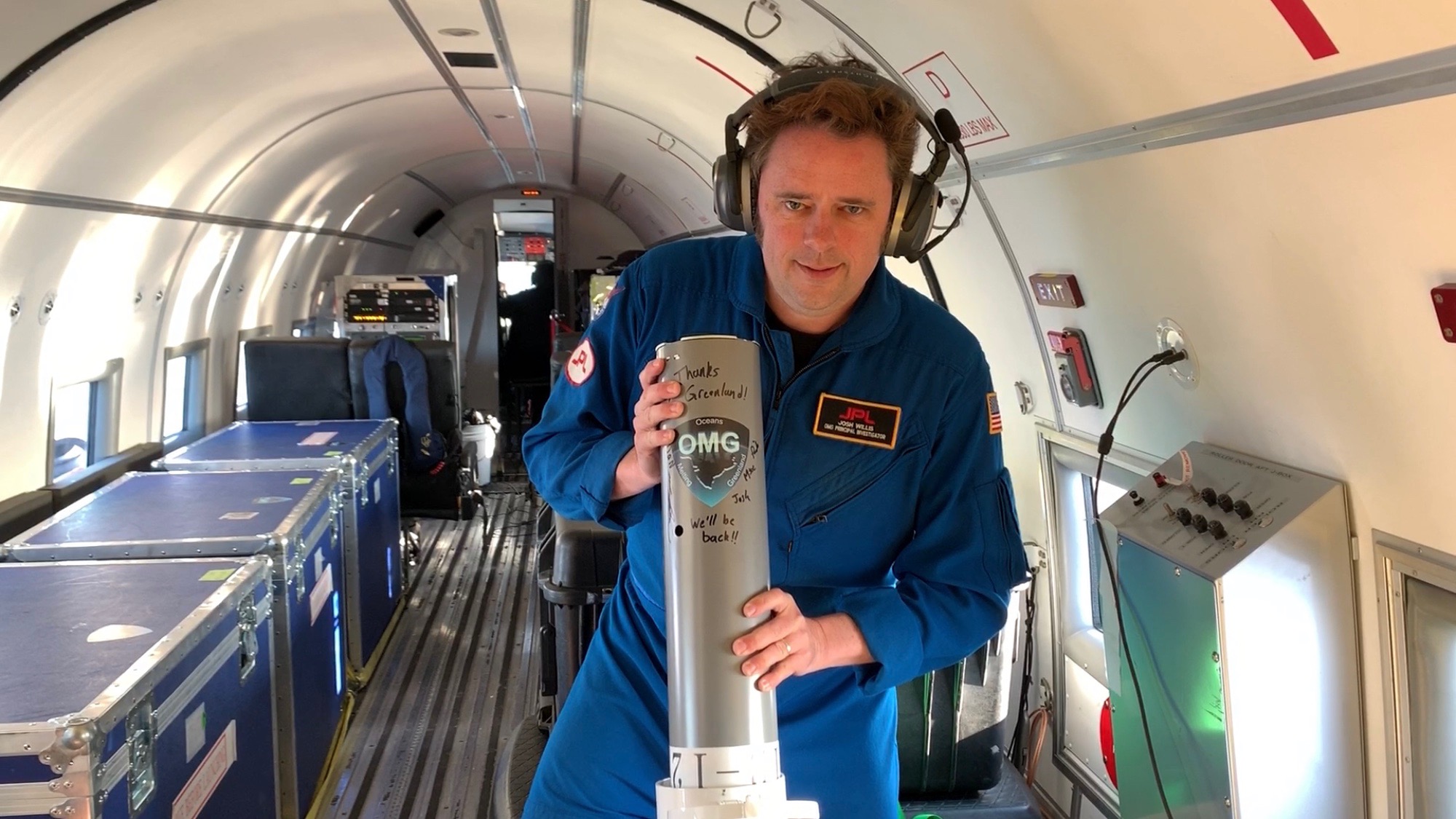 OMG Principal Investigator Josh Willis of NASA's Jet Propulsion Laboratory prepares to release the last ocean probe for OMG's 2019 ocean survey from the interior of an Airtec DC-3 Turbo aircraft.