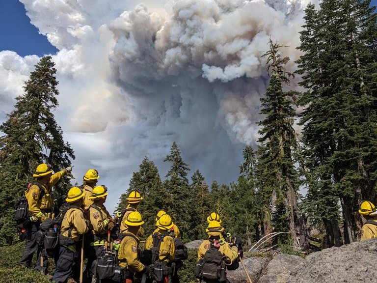 A strike team from Cal Fire watches as smoke from California's Dixie Fire billows overhead in July 2021.