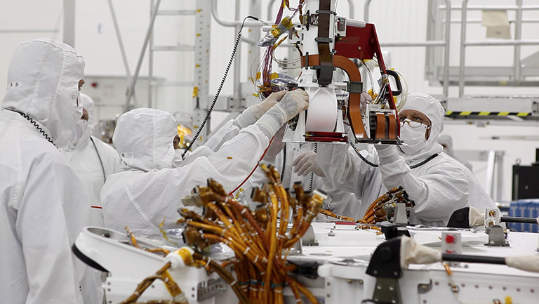 JPL engineers working on hardware in the clean room. Credit: NASA/JPL-Caltech.