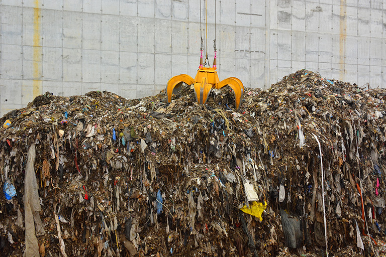 A grapple moves a pile of garbage to the incinerator to be converted to energy in the renewable energy facility instead of being added to a landfill. Photo courtesy of Solid Waste Authority of Palm Beach County.