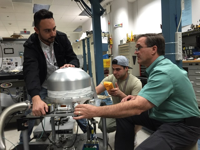 The PRISM instrument at JPL, undergoing testing in preparation for its use in the CORAL campaign by (left to right) CORAL systems engineer Ernesto Diaz, sensor technician Luis Rios and systems engineer Michael Eastwood. Credit: NASA/JPL-Caltech.