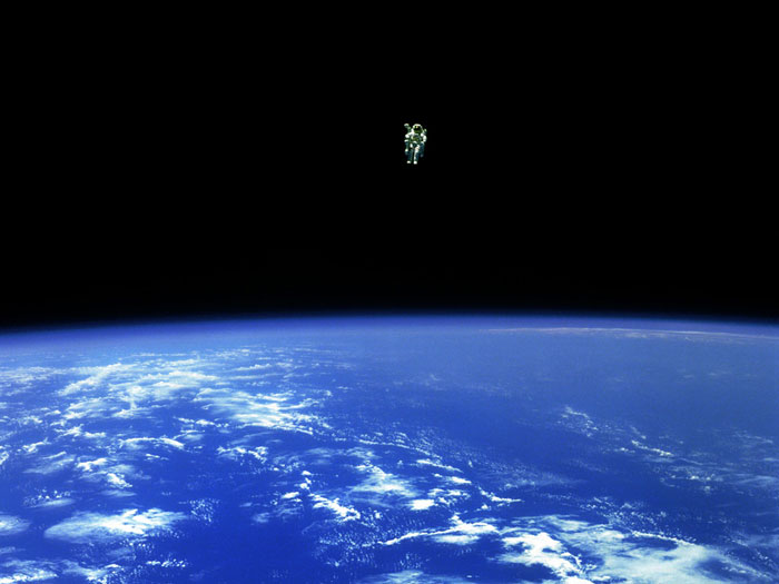 TO BOLDLY GO: February 12, 1984: Mission specialist Bruce McCandless II ventures further away from the confines and safety of his ship than any previous astronaut has ever been. This space first was made possible by the Manned Manuevering Unit or MMU, a nitrogen jet-propelled backpack. After a series of test maneuvers inside and above Challenger's payload bay, McCandless went 'free-flying' to a distance of 320 feet away from the Orbiter. This stunning orbital panorama view shows McCandless out there amongst the black and blue of Earth and space.