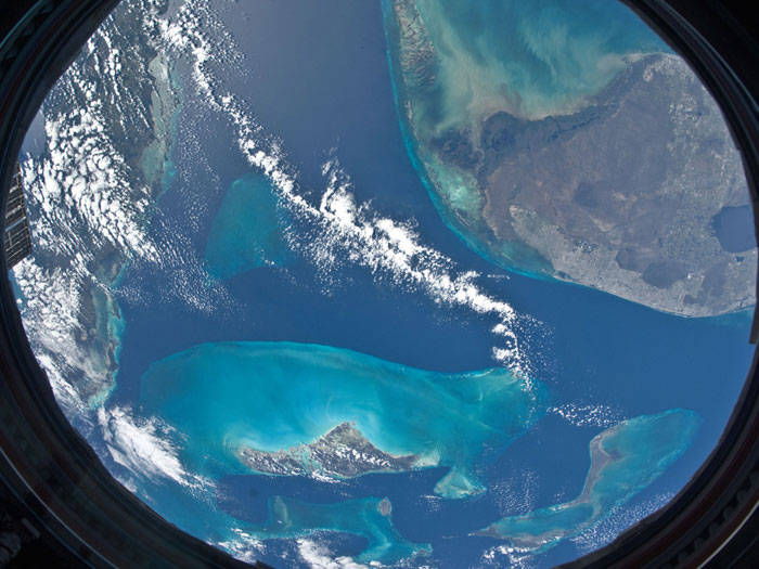 WINDOW TO THE WORLD: Parts of the Atlantic, Gulf of Mexico and Caribbean Sea as seen from the International Space Station 220 miles above Earth, from the Cupola window. The image was taken on November 9, 2010 by one of the Expedition-25 crew members using a 16-millimeter f/2.8D lens, which gives the image a fish-eye effect.