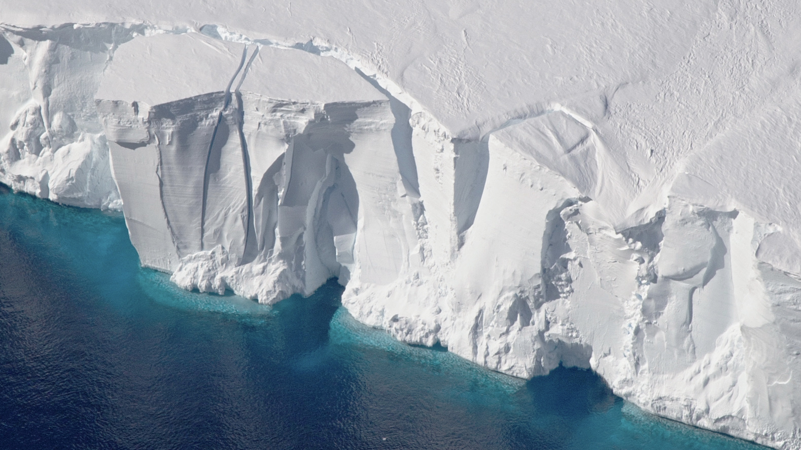 The 200-foot-tall (60-meter-tall) front of the Getz Ice Shelf in Antarctica is scored with cracks where icebergs are likely to break off, or calve, in this 2016 photo. The first estimate of Antarctic calving has found that since 1997 ice shelves have lost as much ice from calving as from melting. Credit: NASA/GSFC/OIB

