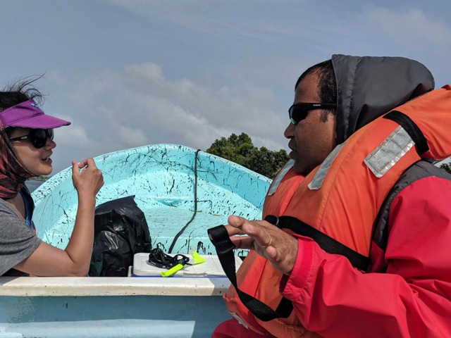 two people talking on a boat