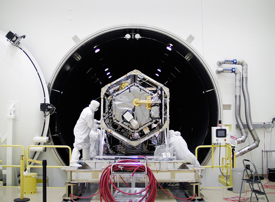 NASA's Orbiting Carbon Observatory (OCO)-2 spacecraft is moved into a thermal vacuum chamber at Orbital Sciences Corporation's Satellite Manufacturing Facility for a series of environmental tests. Credit: Orbital Sciences Corporation/NASA/JPL-Caltech.