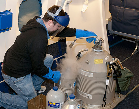 On board the DC-8 aircraft, Justin Trice of Exelis Inc. readies liquid nitrogen that will be used to cool part of the Multi-functional Fiber Laser Lidar, or MFLL, a system that uses laser light to measure atmospheric carbon dioxide.
Credit: NASA/Tom Tschida