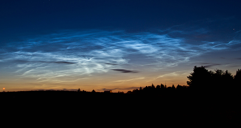 Pictured here are rare clouds, technically called "noctilucent" or "polar mesospheric" clouds, spotted over Billund, Denmark on July 15, 2010. Credit: Jan Erik Paulsen. View and download large image.