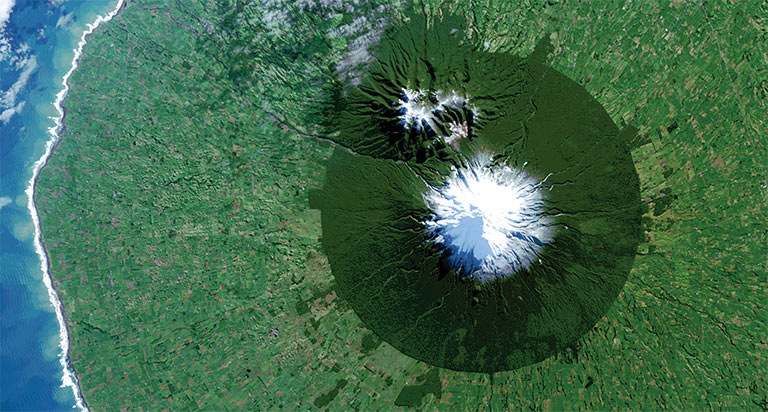 In July 2014, Landsat 8 captured the isolated island of protected forest around New Zealand’s Mt. Taranaki in Egmont National Park surrounded by once-forested pasturelands. Credit: NASA/USGS