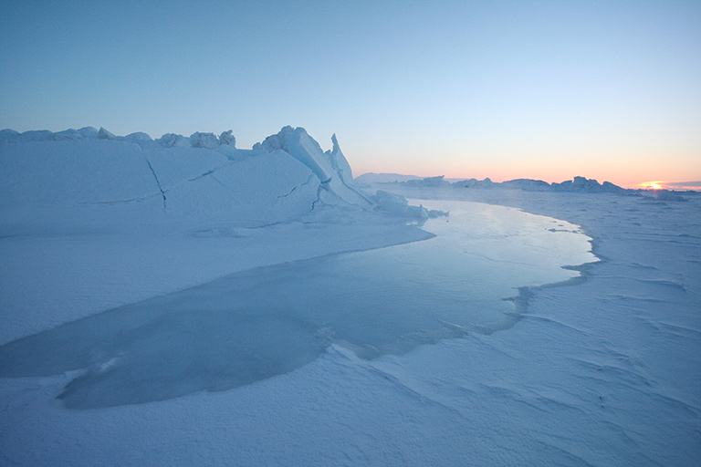 The tide coming in over ice in Greenland. Credit: National Snow and Ice Data Center/Andy Mahoney.
