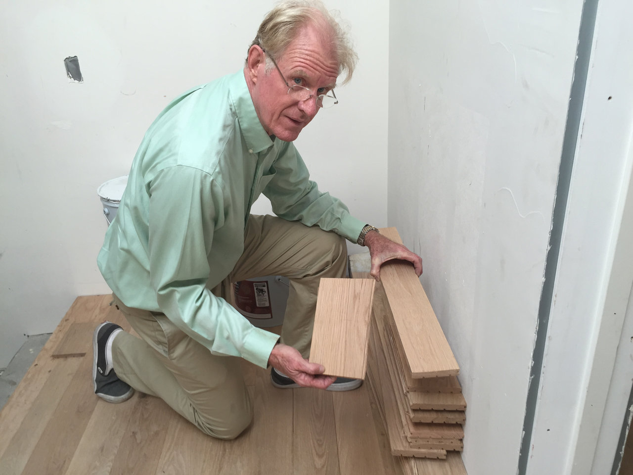 Ed Begley Jr. inspects his oak hardwood flooring, which is 100 percent sourced from old barns and buildings.