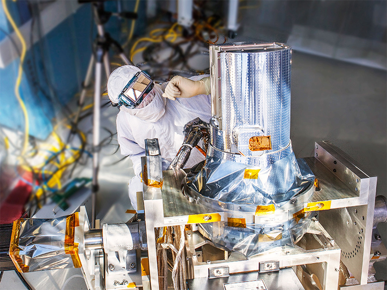 NASA engineer Chip Holloway waits for the sun to align with the Stratospheric Aerosol and Gas Experiment, or SAGE, III instrument during a clean room "sun-look" test on March 4, 2013, at NASA's Langley Research Center in Hampton, Virginia. SAGE III passed this test, successfully locking onto the sun and completing a series of measurements. SAGE III will measure aerosols, ozone, water vapor and other gases to help scientists better understand levels of ozone in the Earth's atmosphere. Credit: NASA Langley/Sean Smith.