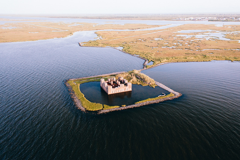 The ruins of a Civil War-era structure, Fort Beauregard, lie partially submerged east of New Orleans. Researchers say many large coastal cities around the world sink faster than sea levels rise.&nbsp;Credit: Frank McMains.