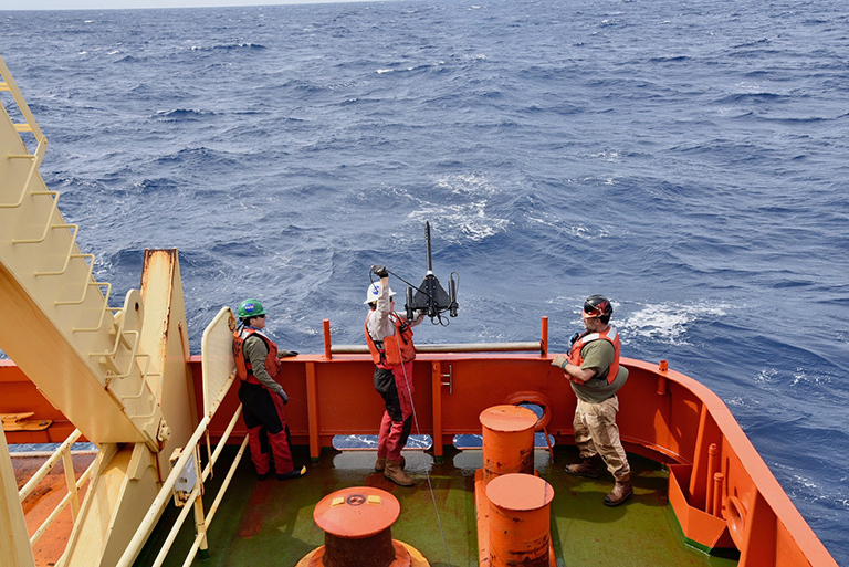 The crew prepares to deploy the radiometer from the stern of the R/V Nathaniel Palmer to measure the optical properties of the water from the surface down all the way down to the bottom of the photic zone. Credit: Lena Schulze/FSU.