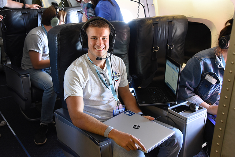 Student Airborne Research Program (SARP) participant Arie Feltman-Frank aboard the DC-8 monitoring air pollution on June 25, 2018. Credit: NASA/Megan Schill
