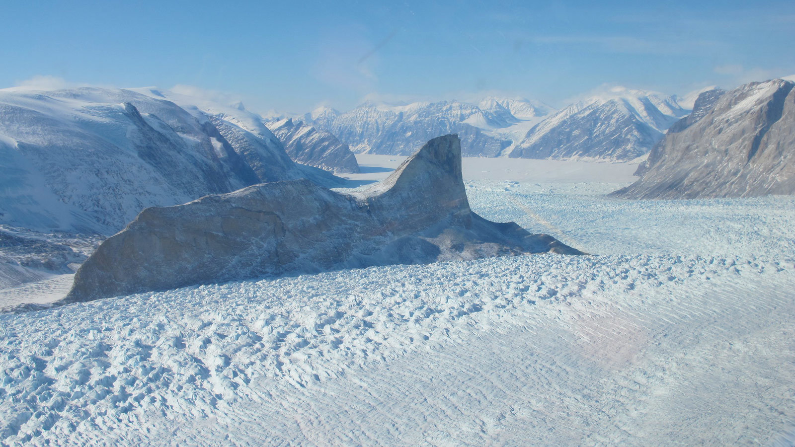 The Kangerdlugssup (pictured) and Jakobshavn glaciers in Greenland have lost roughly 14 to 20 feet (4 to 6 meters) of elevation per year over the past 16 years. Credit: NASA/Jim Yungel
› Larger view