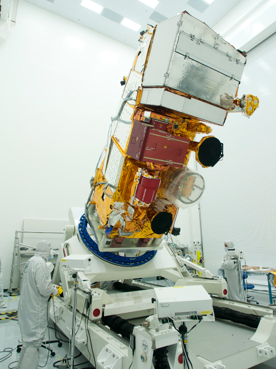 The NPP spacecraft in a cleanroom at Ball Aerospace undergoes inspection by a technician following electromagnetic compatibility testing. Credit: Ball Aerospace