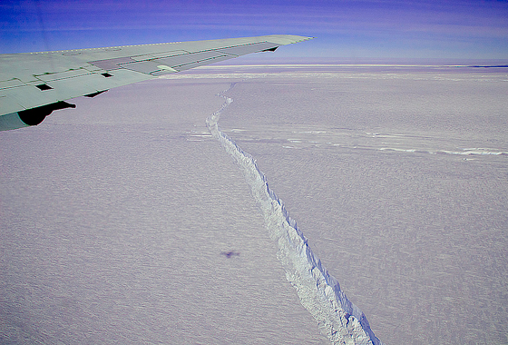 A photo from the window of NASA's DC-8 shows the rift across the Pine Island Glacier ice shelf running off toward the horizon.Credit: Michael Studinger/NASA