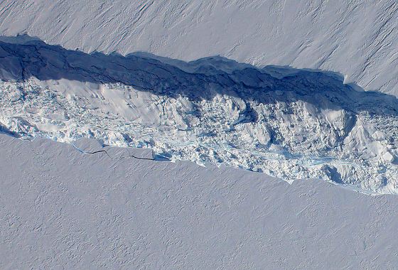A close-up image of the crack spreading across the ice shelf of Pine Island Glacier shows the details of the boulder-like blocks of ice that fell into the rift when it split. For most of the 18-mile stretch of the crack that NASA’s DC-8 flew over on Oct. 26, 2011, it stretched about 240 feet wide, as roughly seen here. The deepest points ranged from about 165 to 190 feet, roughly equal to the top of the ice shelf down to sea level. Scientists expect the crack to propagate and the ice shelf to calve an iceberg of more than 300 square miles in the coming months. This image was captured by the Digital Mapping System (DMS) aboard the DC-8. Credit: NASA/DMS.