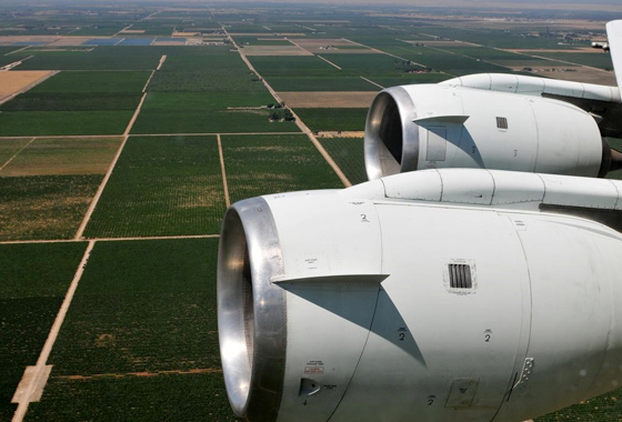 NASA's DC-8 airborne science laboratory flew low over San Joaquin Valley farm fields while specialized instruments collected data during the vegetation canopy and soil moisture study. Credit: Jane Peterson/NSERC.