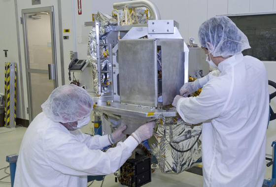 Technicians prep the OCO-2 instrument for shipping at JPL. The instrument consists of three parallel, high-resolution spectrometers, integrated into a common structure and fed by a common telescope. Credit: NASA/JPL-Caltech.